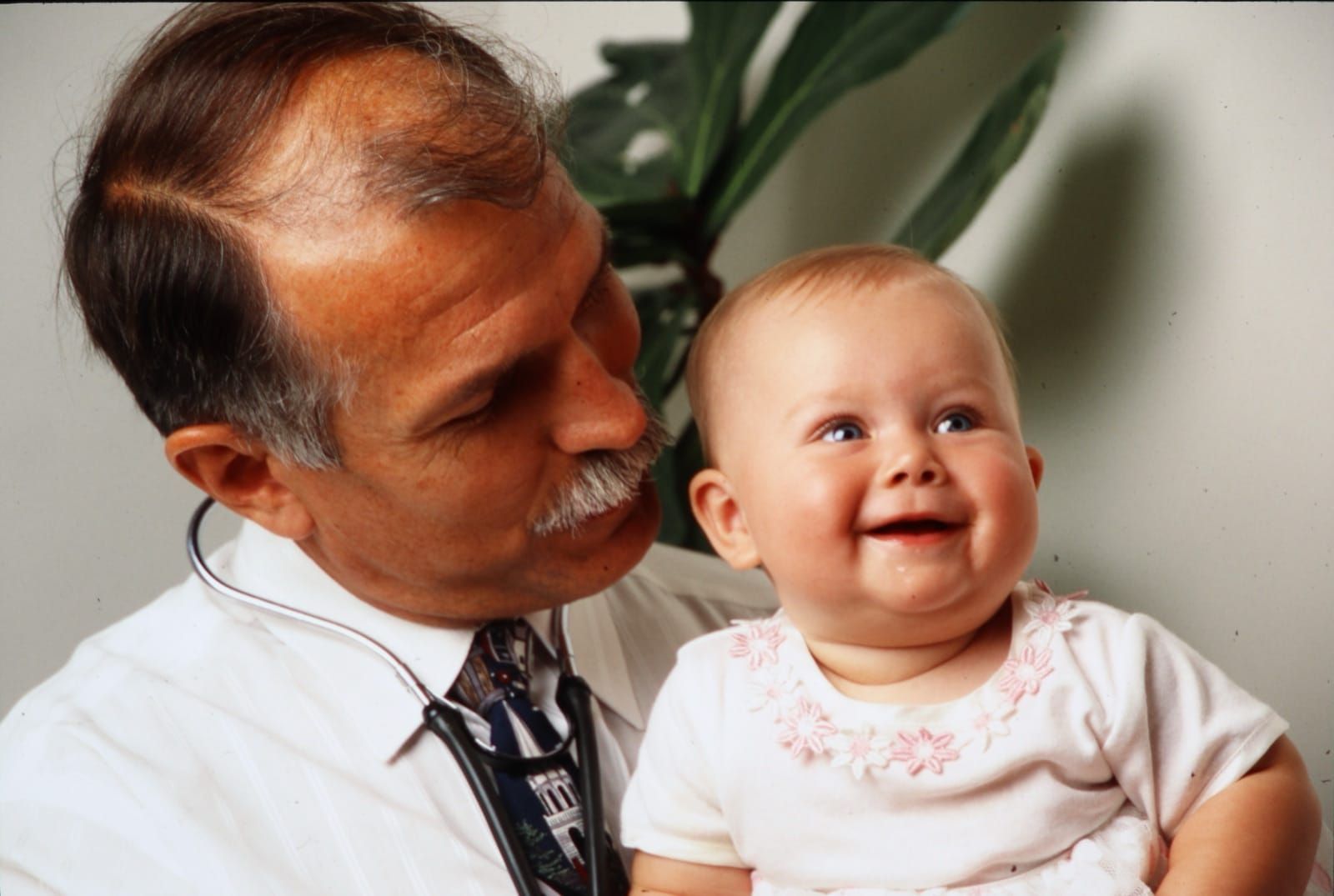 A Pierre Rural family physician with an infant patient — full-spectrum family medicine from the beginning