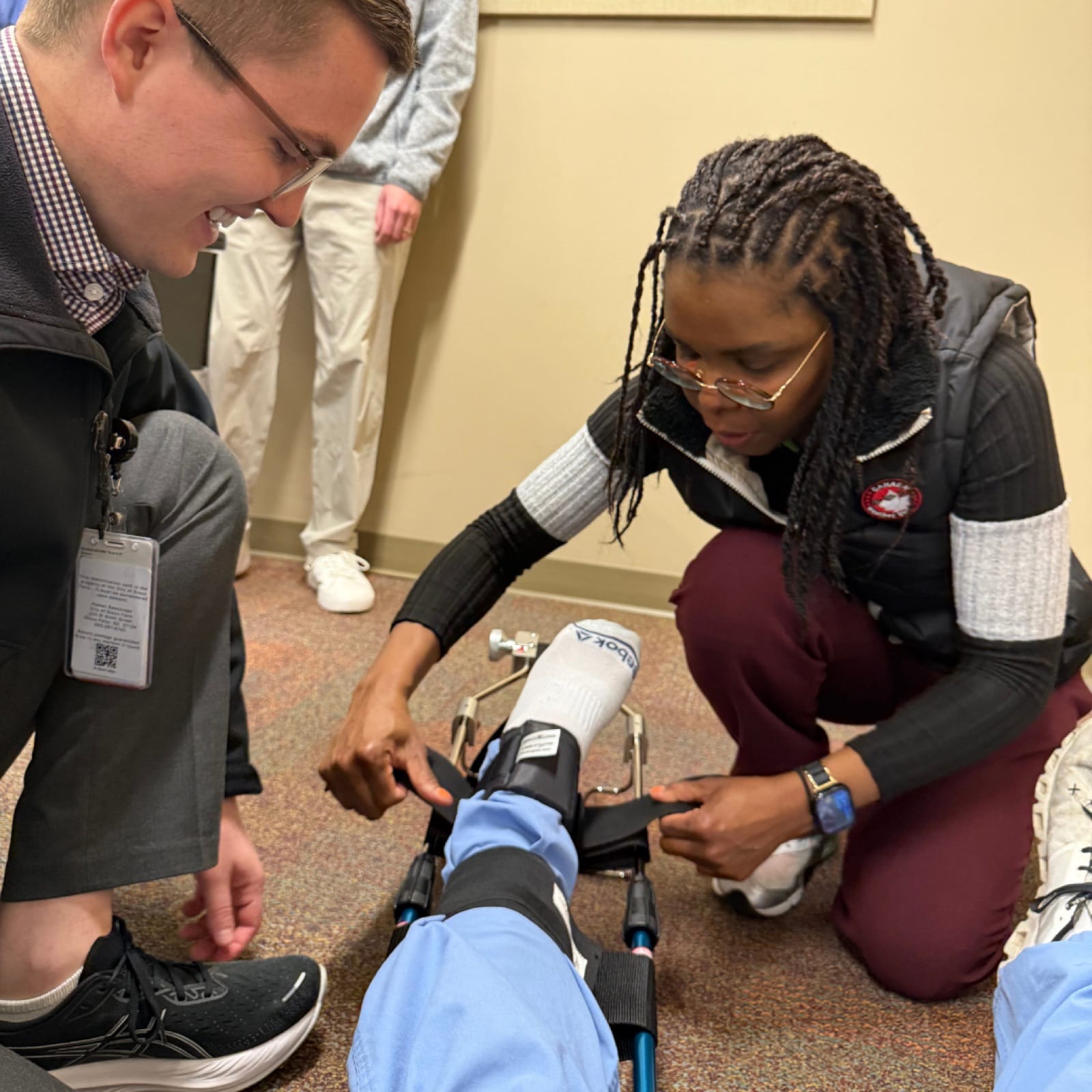 Two residents practicing a knee joint injection in the simulation lab